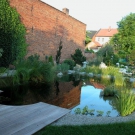 Beautiful swim pond cleverly placed into garden.